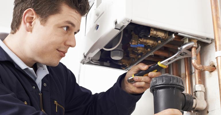 Picture of plumber working on water heater