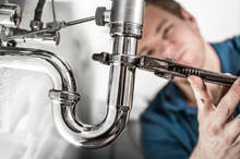 picture of plumber under sink 