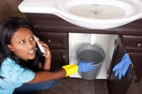 Picture of woman under clogged sink 