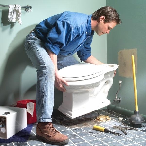 Plumber installing new toilet 
